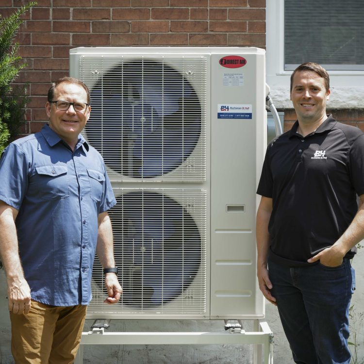 Mike and Josh with outdoor air source heat pump unit.